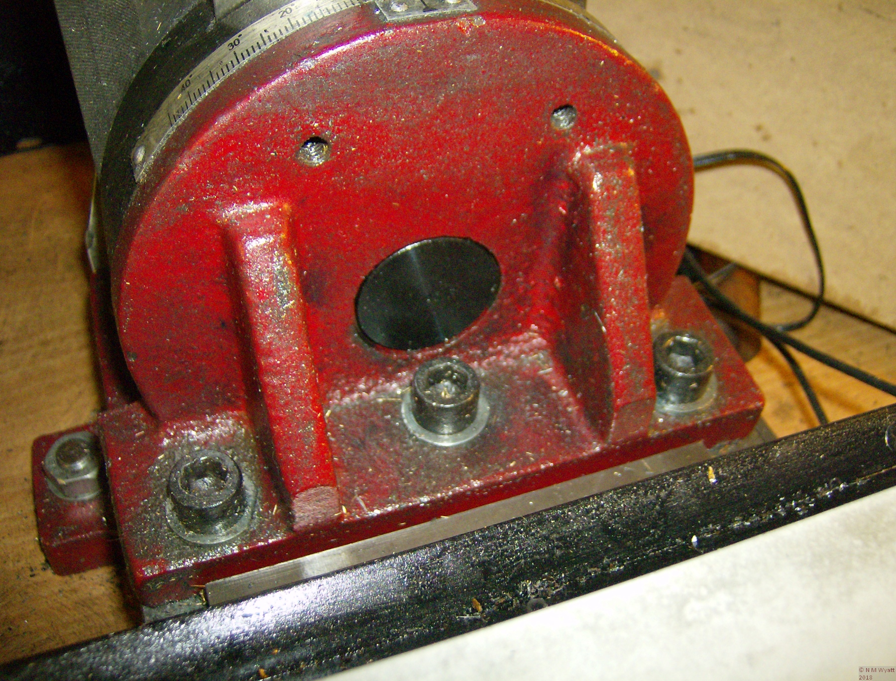 The three fixings in a straight line